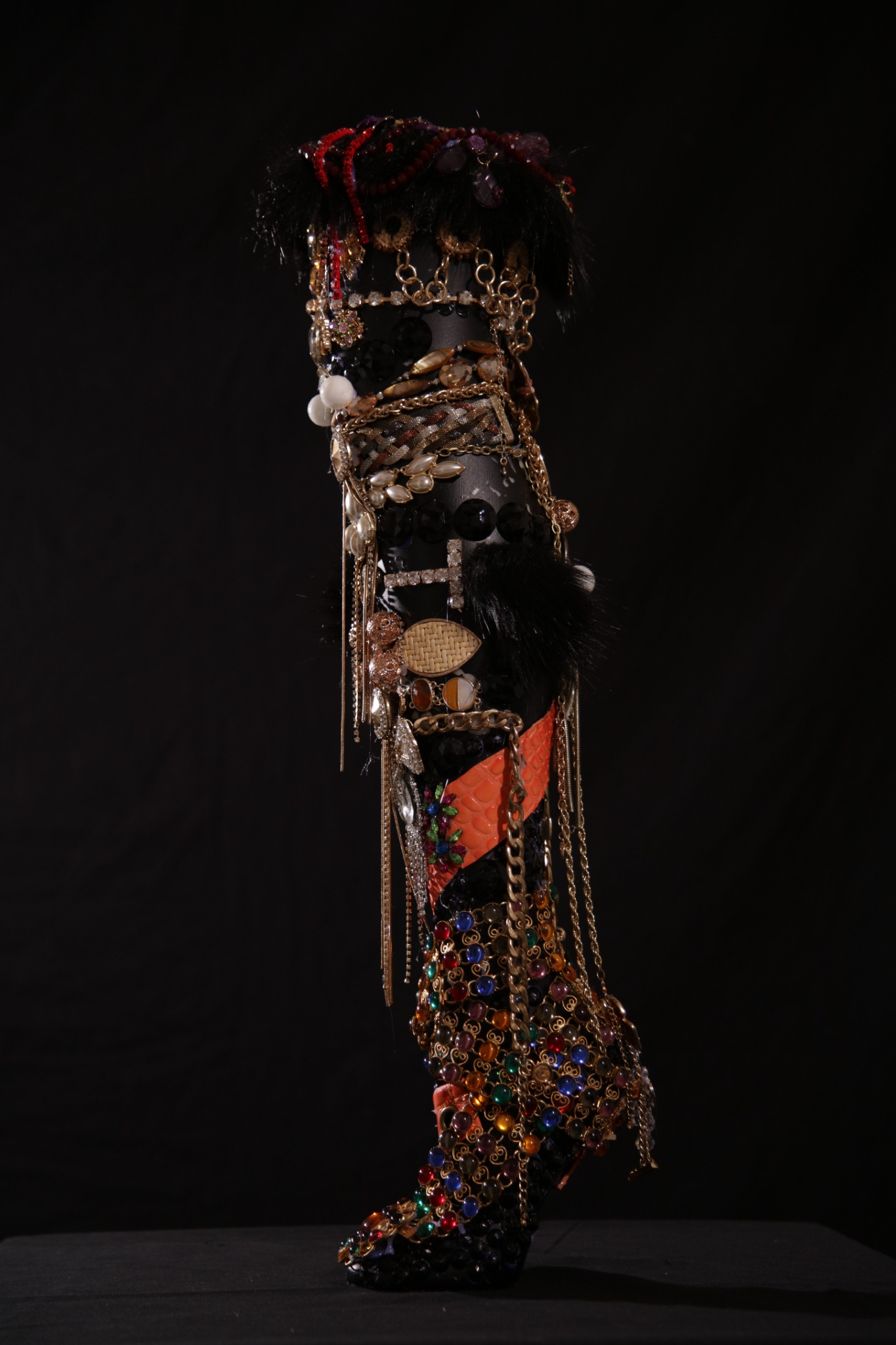 The Performer sculptural leg made with drag materials, jewelry, beads, chains, and hair
